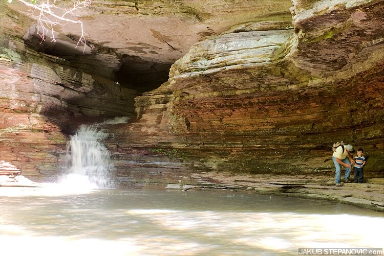 Before reaching the big falls, there are these small ones. See that tunnel they are coming from? You can actually climb through it to the other side of the rock wall, around 70 feet my guess.