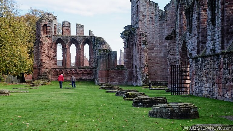 Visitors contemplate above the tombstone of William the Lion, the king of Scotland from 1165 to 1214.