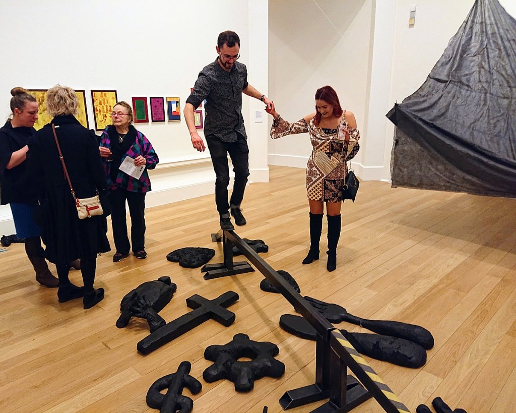 Visitors interact with Jakub Stepanovic's artwork, Balance, in the Royal Scottish Academy.